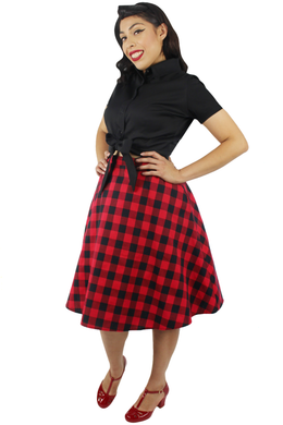 Model wearing black knot top with plaid red and black circle skirt, Pictured from the side