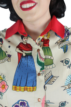 Load image into Gallery viewer, Close up of upper top, Red collar, Snap up closure, Cartoon images of Frida on the blouse