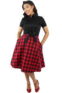 Model wearing black knot top with plaid red and black circle skirt, Pictured from the front